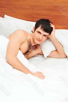 Man lying in bed smiling