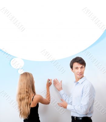 Confident adult teacher helping to students  in school classroom