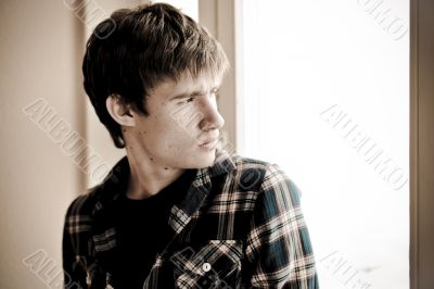 Happy young handsome man at home