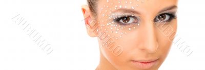 Portrait of young beautiful woman with crystals on face - isolat