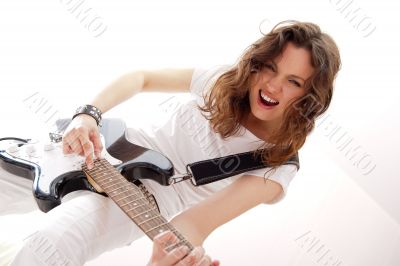 Portrait of beautiful young and attractive womanplaying her guit