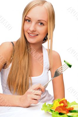 A beautiful slender girl eating healthy food