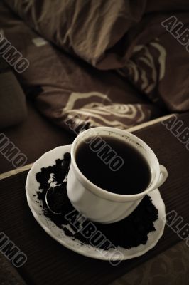 warm cup of coffee on brown background