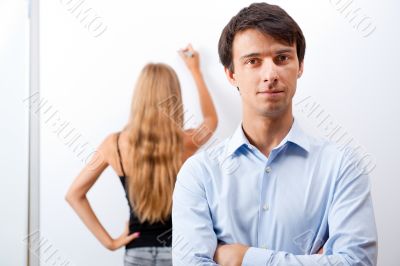 Closeup of adult teacher with student presenting her work on whi