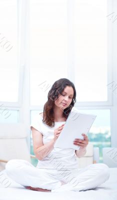 Young woman with a notebook studying at home