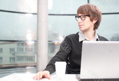 Friendly executive sitting in front of laptop