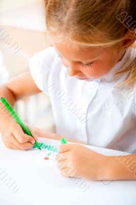 Little girl looking for a drawing concept wile painting picture 