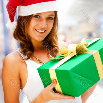 Portrait of young excited pretty woman standing inside shopping 