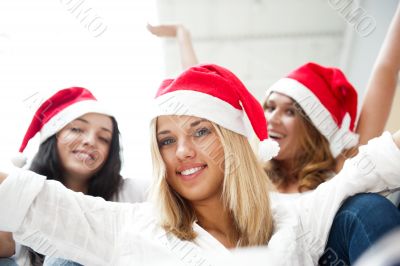 Group of three happy pretty girls are celebrating christmas and 