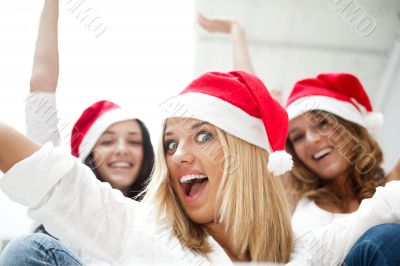 Group of three happy pretty girls are celebrating christmas and 