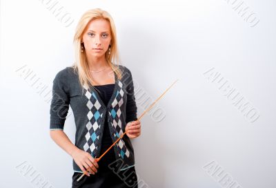 Portrait of young teacher pointing on white marker board in mode
