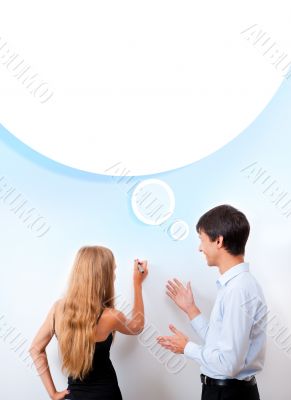 Confident adult teacher helping to students  in school classroom