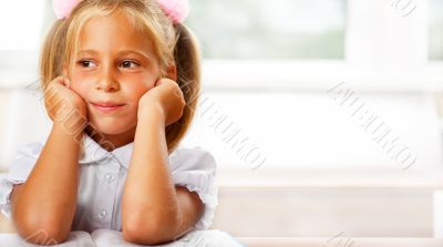 Image of smart child reading interesting book in classroom