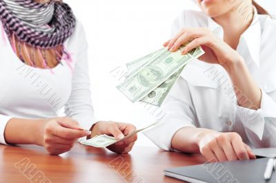 Portrait of two young pretty women in an offive environment.