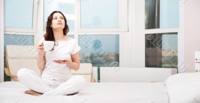Closeup portrait of a pretty young female having a cup of coffee
