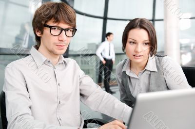 Portrait of confident business man explaining a project to colle