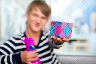 Portrait of young man inside shopping mall standing relaxed and 