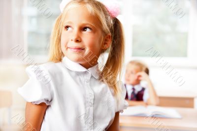 Portrait of a schoolgirl being in a classroom at school with her