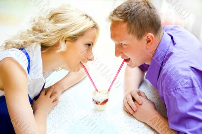 Closeup portrait of young cute couple at mall cafe. 