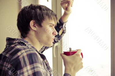 Happy young handsome man at home