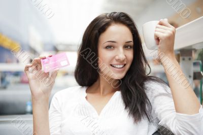 Closeup portrait of a pretty young female having a cup of coffee