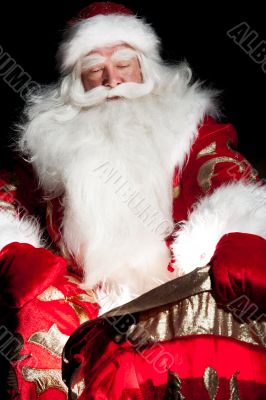 Santa sitting at the Christmas room and looking into the sack
