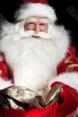 Santa sitting at the Christmas room and looking into the sack