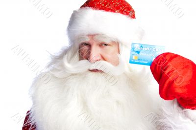 Traditional Santa Claus holding and sowing credit card while giv