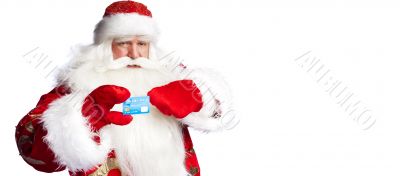 Traditional Santa Claus holding and sowing credit card while giv