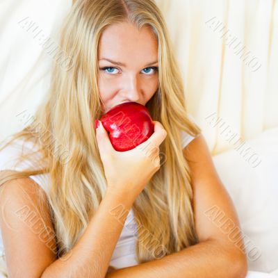 Closeup portrait of young pretty woman lying in her bed at morni