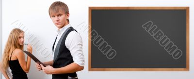Two students - girl and boy making presentation at classroom
