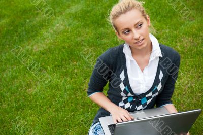 Beautiful young woman using laptop at outdoor