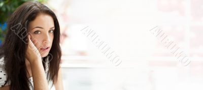 Portrait of young pretty woman talking with someone using cell p