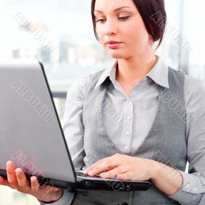 Beautiful business woman concentrating while working on computer