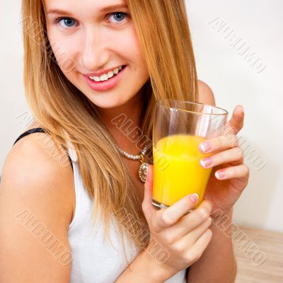 Portrait of beautiful relaxed young woman standing at the kitche