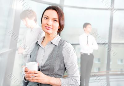 Portrait of a cute business woman with colleagues at the backgro