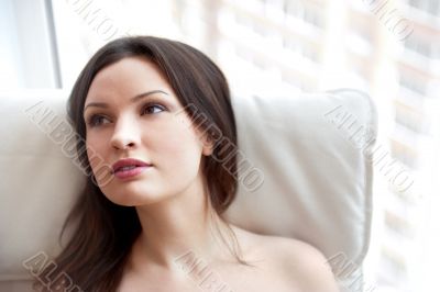 Portrait of smiling beautiful young brunette woman at home