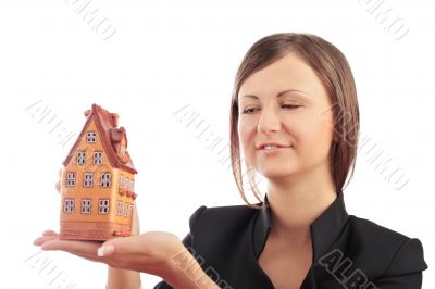 Portrait of young handsome woman holding car in her arms