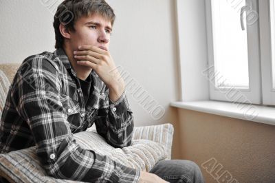 Happy young handsome man at home