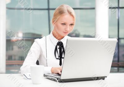 Beautiful business woman thinking about something while working 