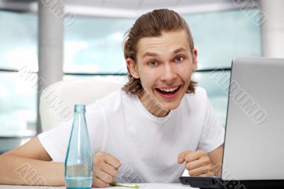 Portrait of handsome young man working with laptop on freelance 