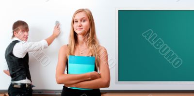 Two students - girl and boy making presentation at classroom