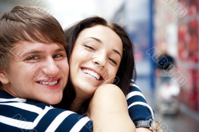 Young man meeting his girlfriend with opened arms at airport arr