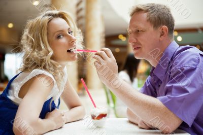 Closeup portrait of young cute couple at mall cafe. Man proposin