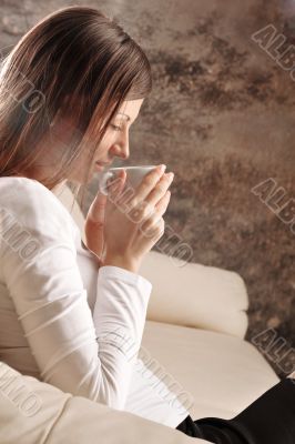 Closeup portrait of pretty caucasian woman sitting on comfortabl