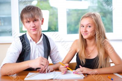 Portrait of college students working indoors looking happy