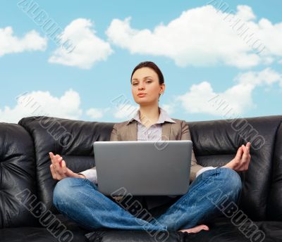 Portrait of young business woman sitting with a laptop on comfor