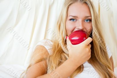 Closeup portrait of young pretty woman lying in her bed at morni