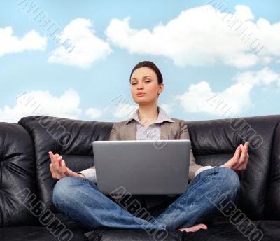 Portrait of young business woman sitting with a laptop on comfor