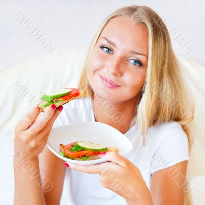 Woman having breakfast in bed. Healthy continental breakfast. Ca